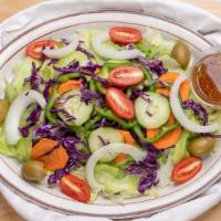 Garden Salad · Crisp iceberg lettuce, carrots, cucumber, onions, red cabbage, fresh tomatoes, green peppers...