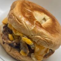 Steak Egg Cheese Bagel  · Steak with grilled onions and fried egg with cheese on a bagel