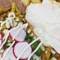Chilaquiles · Deep fried corn tortillas served with red or green sauce ,queso fresco ,sour cream ,onions a...