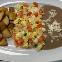 Ranchero Eggs (Eggs Over Easy) · Served with ranchero sauce ,refried beans braekfast potatoes and your choice of corn or flou...