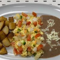 Huevos A La Mexicana (Mexican Style Eggs) · Served with refried beans,breakfast potatoes comes with 3  corn or flour tortillas