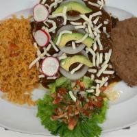 Mole Enchiladas · 3 Chicken enchiladas covered in a delicious mole sauce served with Mexican rice and refried ...