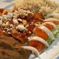 Red Enchiladas (Guajillo Enchiladas) · 3 Red Enchiladas with red guajillo sauce comes with Mexican rice ,refried beans and queso fr...