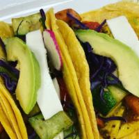 Veggie Tacos · 2 tacos full of veggies like zucchini ,peppers ,onions 
lettuce and roasted corn