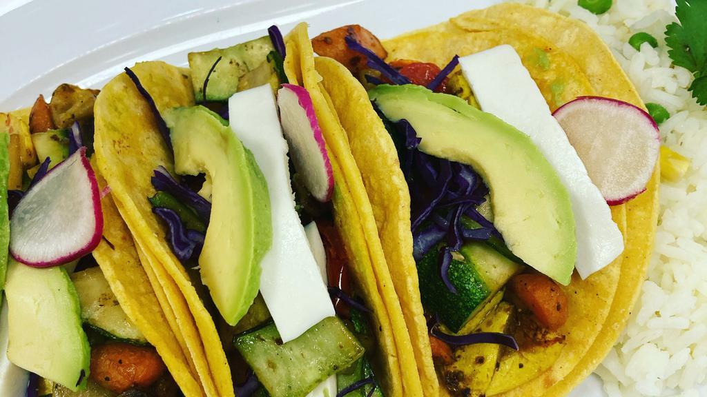 Veggie Tacos · 2 tacos full of veggies like zucchini ,peppers ,onions 
lettuce and roasted corn