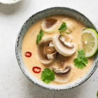 Cup Tom Yum Soup  · Medium spicy. Mushrooms, tomatoes in a spicy broth with a touch of lemongrass and lime leaves.