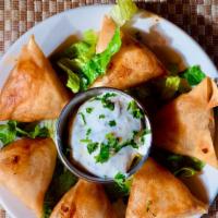 Samosa · (6 pieces Phyllo dough stuffed with pureed vegetables and pan-fried until crispy served with...