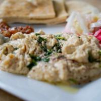 Hummus · Most Popular. Dip. Ground garbanzo beans mixed with tahini, garlic, and lemon topped with pa...