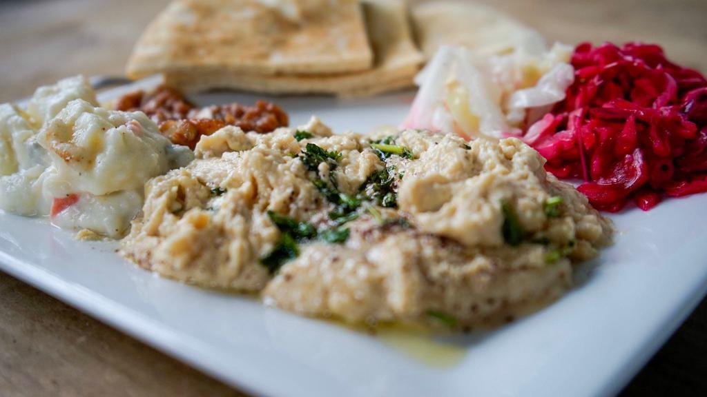 Hummus · Most Popular. Dip. Ground garbanzo beans mixed with tahini, garlic, and lemon topped with parsley and olive oil. Served pocket pita bread.