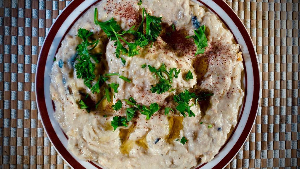 Babaghanooj · Dip. Smoked and roasted eggplant mixed with tahini, garlic, and lemon topped with olive oil and parsley. Served with pocket pita bread.