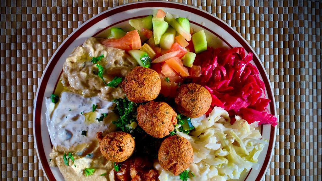 Mazza Platter · Choice of personal or family size. Served with hummus, tabouli, falafel, Mediterranean salad, Turkish salad, tahini, and more.