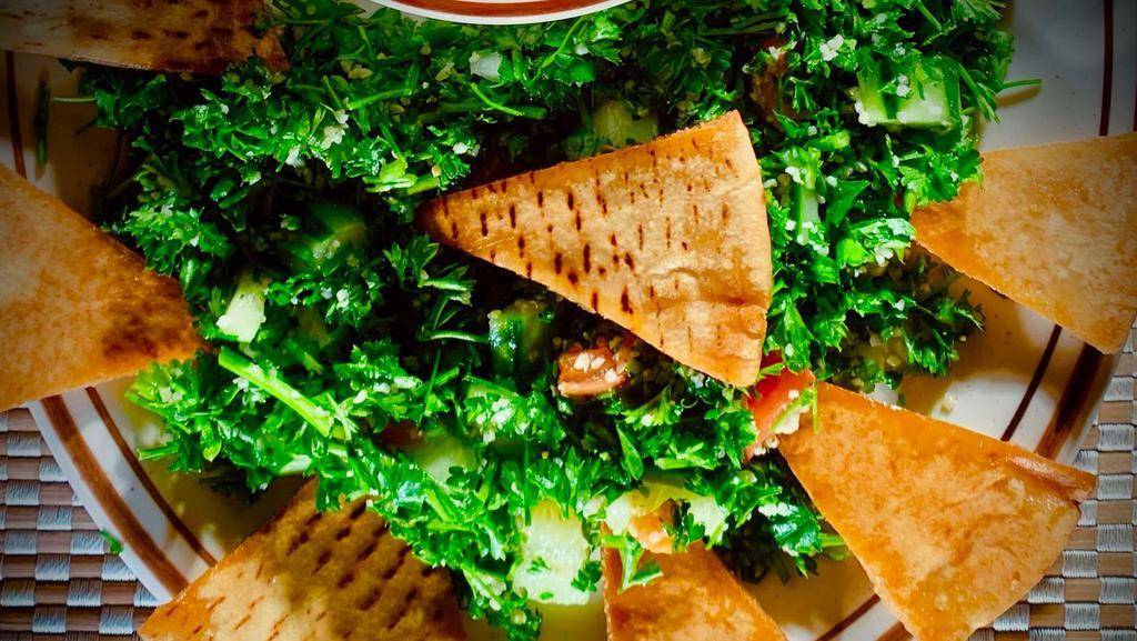 Tabouli Salad · Most Popular. Tossed fresh parsley, green onions, tomatoes, cucumbers, bulgar wheat topped with olive oil and lemon. Served with pocket pita bread.