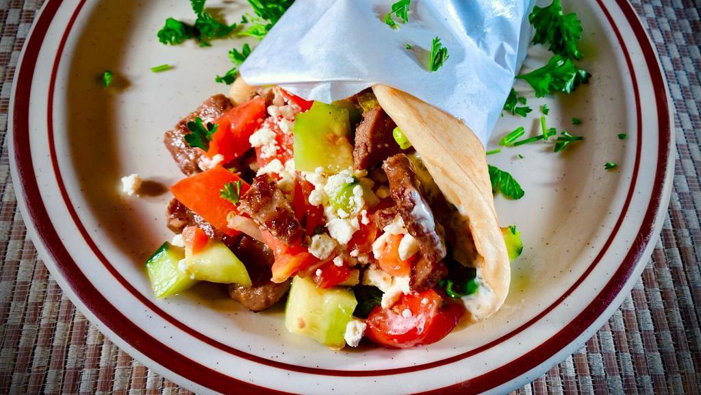 Gyro  · Delicious gyro meat (Beef and lamb mix), savory onion, tomato, fresh feta cheese, and tzatziki sauce on a flat bread.