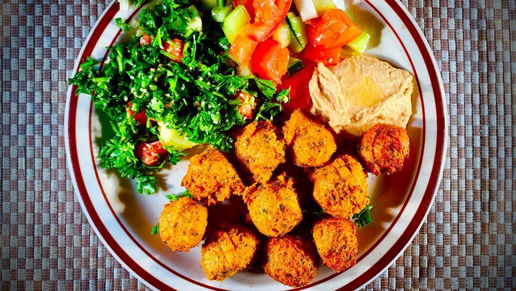 #14 Falafel · Ground garbanzo beans, potatoes, garlic, parsley, onions, spices, fried and served with tabouli, Mediterranean salad and tahini