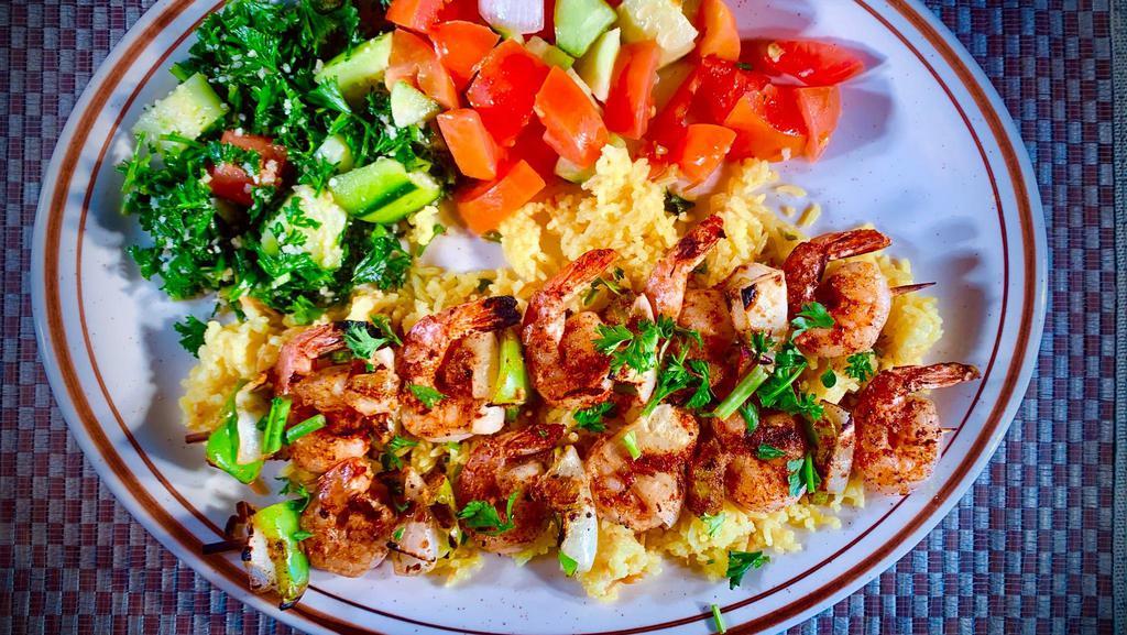 #11 Shrimp Kabobs · Two kabobs grilled with special seasoning topped with garlic and lemon. Includes rice, optional House Salad (Tabouli, Mediterranean Salad, Red and Green Pickled Cabbage, Potato Salad and Salsa).