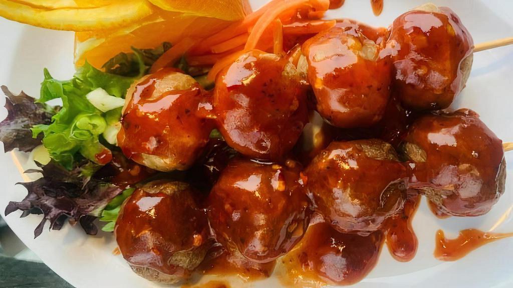 Deep-Fried Pork Meatballs (4) · This portable Thai-style street food is four pork meatballs on a stick that is deep-fried and coated with a homemade Japanese-style sauce.