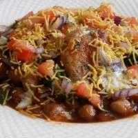 Aloo Tikka Chaat · Spiced 2 potato patties served with garbanzo curry and chutneys.