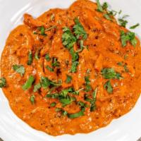 Butter Chicken · Specially marinated chicken, cooked in rich tomato butter creamy sauce.