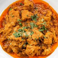 Chicken Curry · Boneless chicken cooked in curry sauce, tossed with garlic, chili, coriander and spices.
