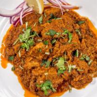 Goat Curry · Goat cooked in special curry sauce, tossed with garlic, chili, coriander and spices.