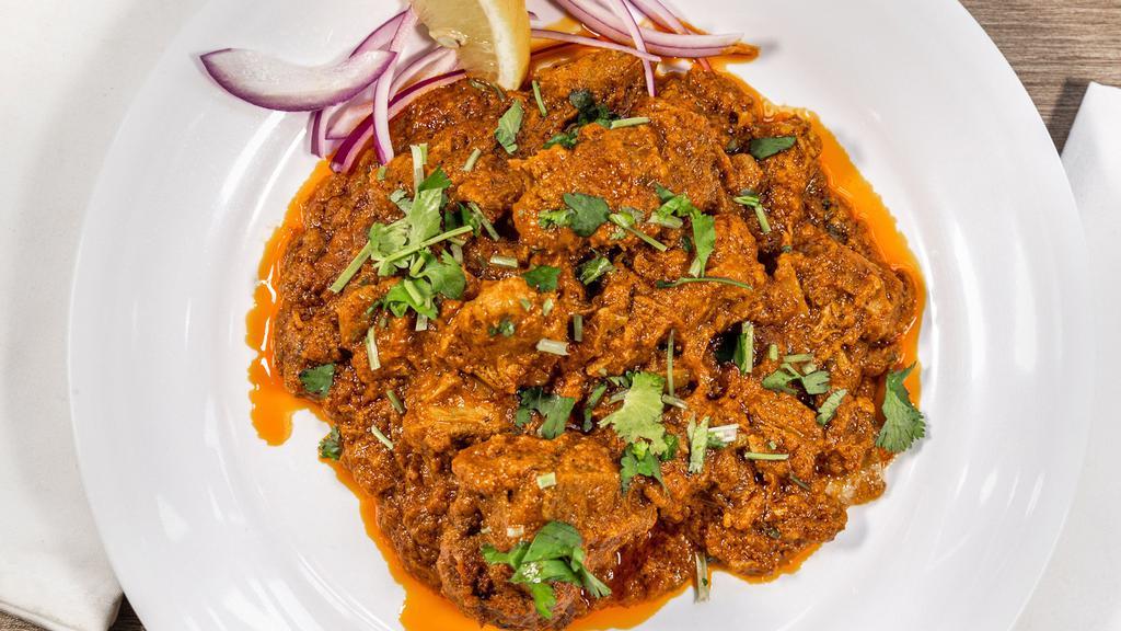 Goat Curry · Goat cooked in special curry sauce, tossed with garlic, chili, coriander and spices.