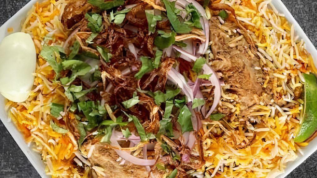 Lamb Biryani · Boneless lamb cooked with spices and tomatoes, layered in basmati rice and exotic spices.