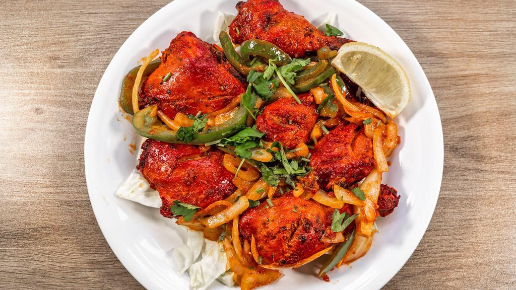 Tandoori Chicken · 6 pieces of chicken marinated and cooked in a clay oven with fresh green herbs and spices