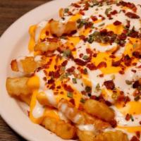 Loaded Pub Fries · Crinkle fries topped with bacon bits, chives, melted cheddar & ranch dressing