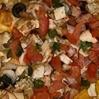 Nachos Deluxe · Nacho chips topped with black olives, cherry peppers, bacon bits, melted cheddar served with...
