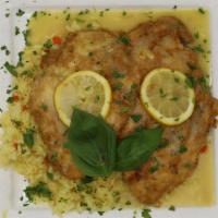Chicken Francese · Cutlets dipped in egg batter and sautéed with lemon and white wine, plated over rice