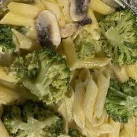 Tortellini · Tri colored tortellini (vegetarian) in a garlic cream sauce with mushrooms, peas and broccoli.
