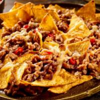 Beef Nacho Supreme · Yummy bean and cheese nachos with your choice of ground beef and a side of guacamole, sour c...