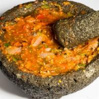 Salsa Molcajete · Deliciously roasted tomatoes, garlic, and peppers to make a spicy and hearty sales.