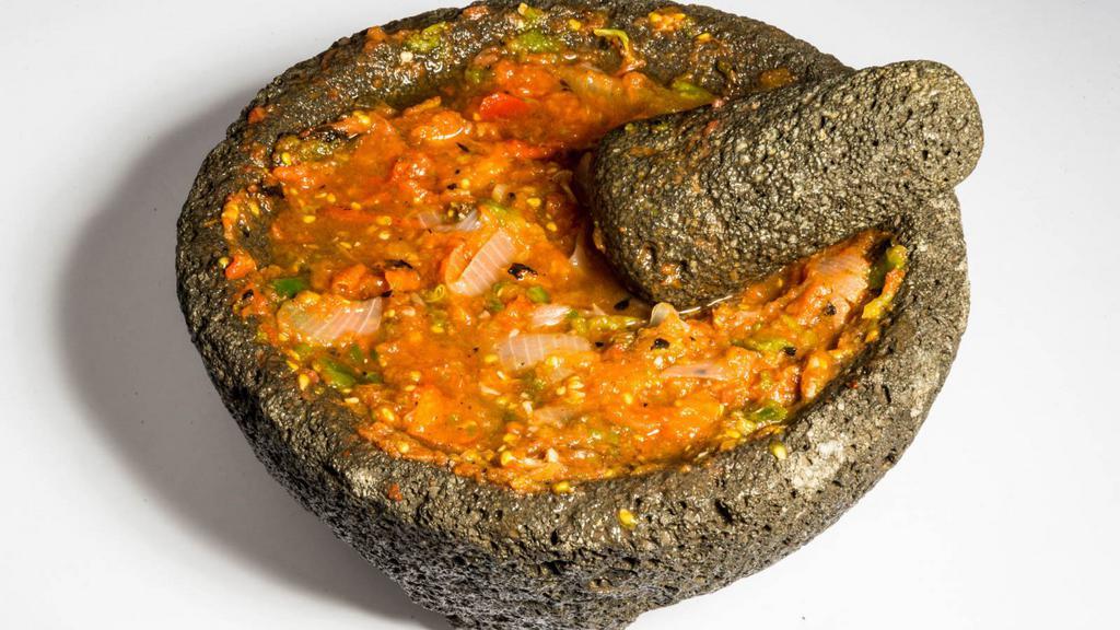 Salsa Molcajete · Deliciously roasted tomatoes, garlic, and peppers to make a spicy and hearty sales.
