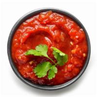 Salsa · Delicious homemade red salsa made with tomatoes, garlic, onions.