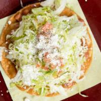 Bean Tostadas · Flat crispy tortilla with beans shredded chicken sour cream lettuce pico de gallo and cotija...