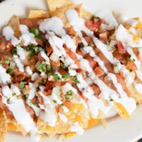 Junior Nachos · Tortilla chips with beans melted cheddar cheese pico de gallo sour cream and cotija cheese. ...