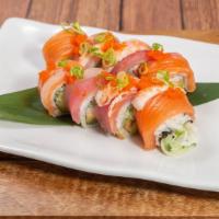 Rainbow Roll · spicy tuna, tempura flake wrapped with salmon, spicy crab sauce, and tempura flake on top.