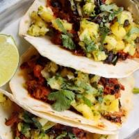 Tacos Al Pastor · Achiote-Marinated Pork, Cilantro, Red Onion, Pineapple Salsa, Lime Wedge, Housemade Corn or ...