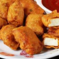 Paneer Pakora · Homemade Indian cheese square, batter dipped, and fried till golden, served with mint, and o...