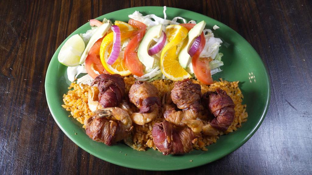 Camarones Locos · Six jumbo shrimp filled with oaxaca cheese, a slice of jalapeño and wrapped with bacon on a bed of rice. Served with fries and salad garnish.