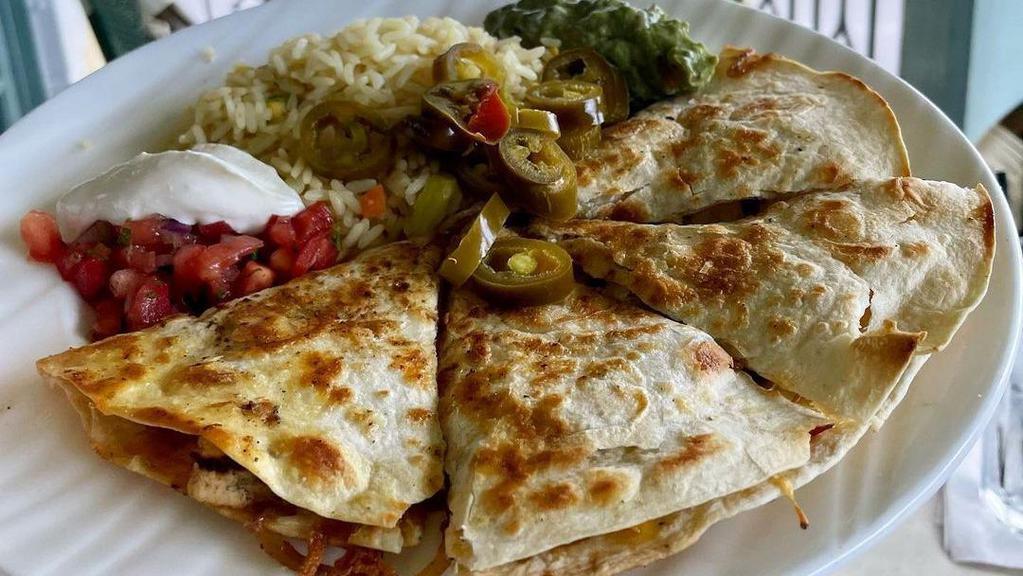 Veggie Quesadilla · Grilled bell peppers, onions, tomatoes, and mushrooms. Served with beans and cheese.