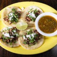 Tacos De Cecina · Taste of Mexico four corn topped will steak chunks, cilantro, and onions. Served with tomati...