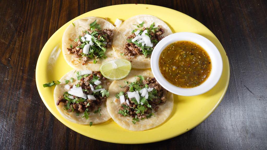Tacos De Cecina · Taste of Mexico four corn topped will steak chunks, cilantro, and onions. Served with tomatillo sauce on the side.