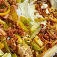 Alambres · Steak or chicken grilled with chorizo and bacon mixed with onions and bell peppers topped wi...