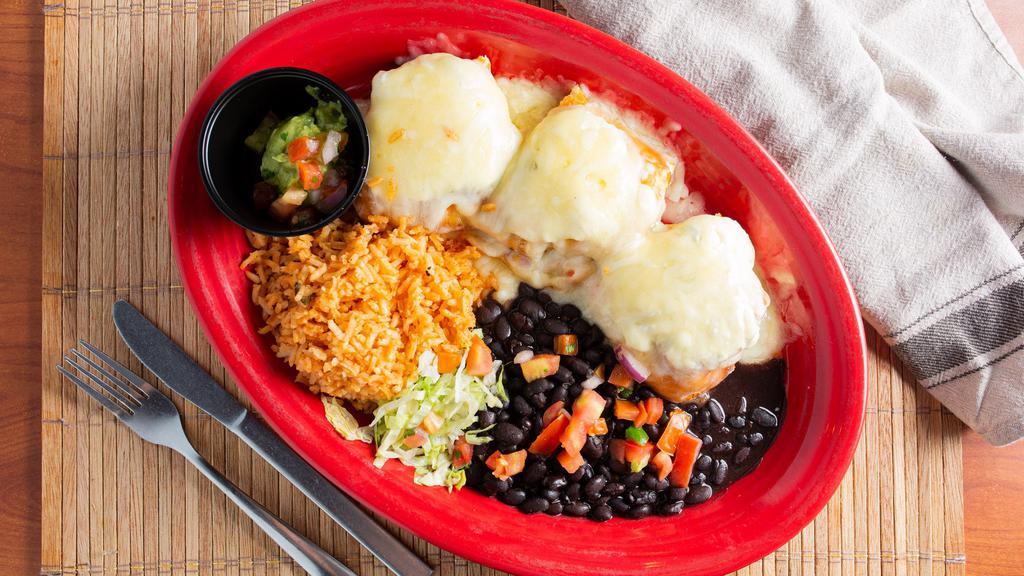 Jalisco Chimichanga · Grilled chicken and pico de gallo stuffed inside a flour tortilla, lightly fried, and baked covered with Monterey jack cheese, and cream cheese, served with black beans and rice.