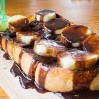 Naughty Nutty French Toast · Three delicious, thick, buttery and fluffy French toast slices, served with a touch of powde...