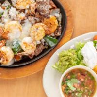 Mix Poblano · Beef steak and shrimp, bacon, tomato, poblano, rajas. Served with rice and beans topped Mont...