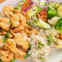 Shrimp Tilapia · Six jumbo shrimps on a grilled tilapia served with bedded spinach and chipotle dressing, ric...