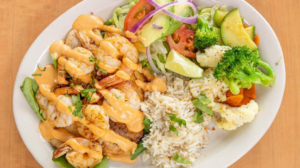 Shrimp Tilapia · Six jumbo shrimps on a grilled tilapia served with bedded spinach and chipotle dressing, rice, salad and vegetables.